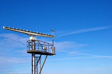 Marine radar tower, rotating antenna. Sea radar in the port of Ventspisls, Latvia.