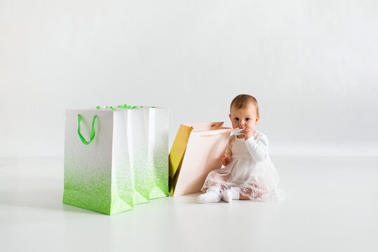 Little girl with paper bags. Shopping concept. Black Friday.