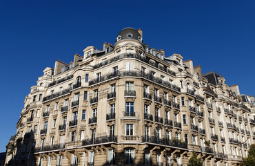 Fototapeta premium The facade of traditional French house with typical balconies and windows. Paris.