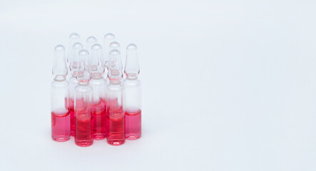 Medicinal or cosmetic ampoules jars of vaccines isolated on white background as a concept of cosmetology medicine and treatment with syringes injections.