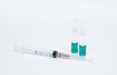 Medicinal or cosmetic ampoules jars of vaccines isolated on white background as a concept of cosmetology medicine and treatment with syringes injections.