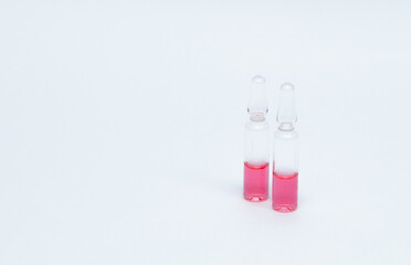 Medicinal or cosmetic ampoules jars of vaccines isolated on white background as a concept of cosmetology medicine and treatment with syringes injections.