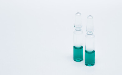 Medicinal or cosmetic ampoules jars of vaccines isolated on white background as a concept of cosmetology medicine and treatment with syringes injections.