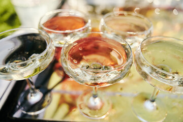 Table set for an event party or wedding reception. Banquet table design. Festive glasses with champagne and white wine.