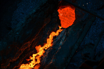 Fototapeta premium The hot inner surface of the metallurgical ladle. A hole in a thick crust of solidified metal
