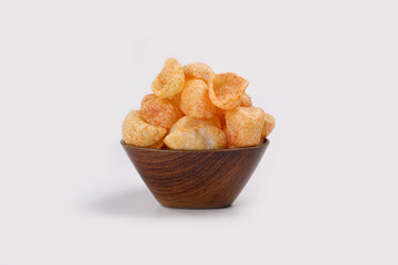 Fried and Spicy Moon Cup, Vatka, Katori, Moon Chips, Snacks or Fryums (Snacks Pellets) served in a bowl or White background. selective focus - Image