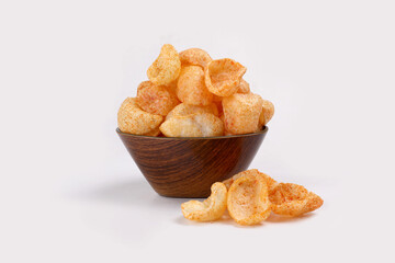 Fried and Spicy Moon Cup, Vatka, Katori, Moon Chips, Snacks or Fryums (Snacks Pellets) served in a bowl or White background. selective focus - Image