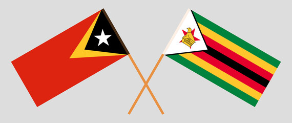 Crossed flags of East Timor and the Republic of Zimbabwe. Official colors. Correct proportion
