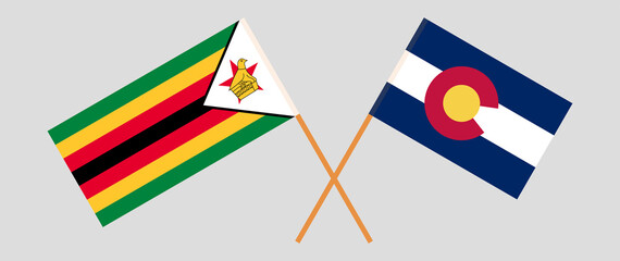 Crossed flags of the Republic of Zimbabwe and The State of Colorado. Official colors. Correct proportion