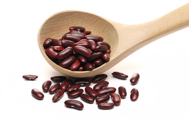 Fototapeta premium Raw red kidney beans in wooden spoon isolated on white 