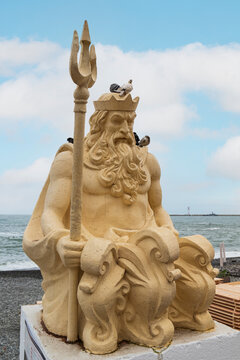 Statue of Neptune with trident at the seafront
