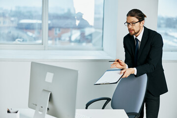 man in a suit at the desk with glasses work Lifestyle