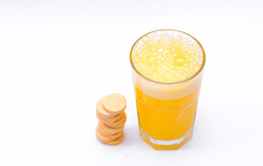 Glass with water on a white background with effervescent tablets vitamins