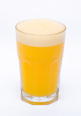 A glass of vitamin orange juice cool on a white background