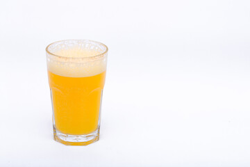 A glass of vitamin orange juice cool on a white background