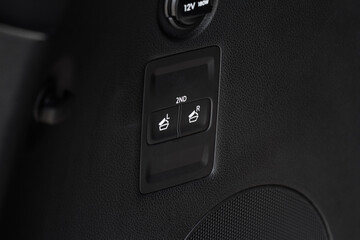 Folding second row seat button