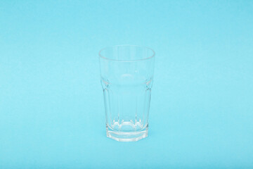 A glass with pure cool water on a blue background