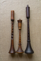 Zhaleika and two shawms (schalmeis) - three folk woodwind reed musical instruments different in tone, shape, color and size