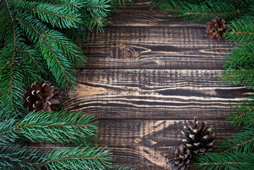 christmas decoration fir branches and cones on a wooden table