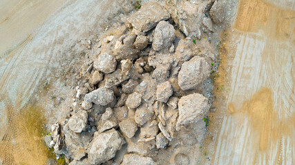 Open pit gravel mining sight with gravel field, big stones and beautiful autumn nature photographed from above with a drone. Mining industry 