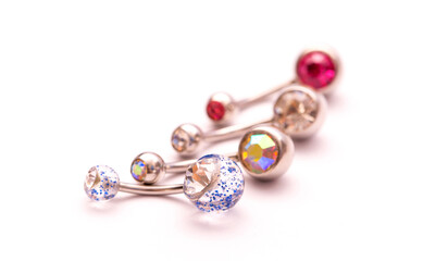 A set of jewelry for piercing on a white background. A set of earrings for the body, nose, navel, tongue, nipples, ears, various beauty jewelry, a set of cosmetological jewelry for piercing.