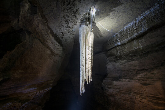 illuminated large stalactite in doolin cave in ireland