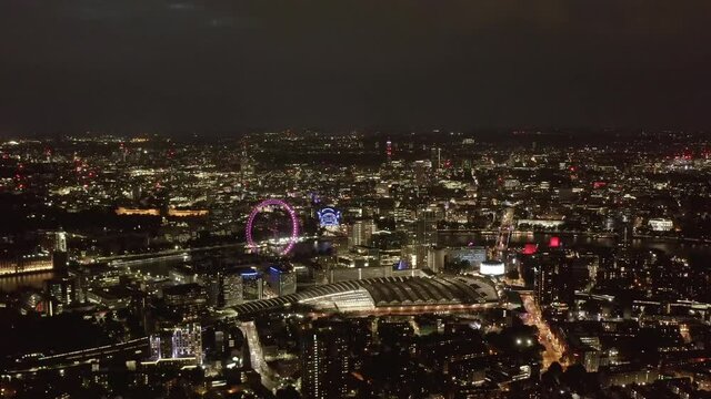 Aerial panoramic view of city at night. Waterloo train station and London Eye tourist attraction. London, UK