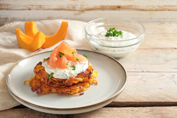 Vegetable fritters or pancakes from red kuri squash with cream cheese dip, smoked salmon and herb...