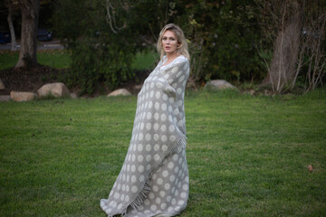 beautiful one woman in park dancing running and turning  in gray plaid or blanket with white dots