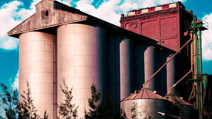 View in perspective from a low angle view of a group of silos from a flour factory in a country town near Cordoba Argentina