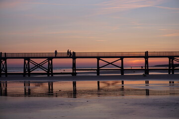 sunset on the  old wooden pier on west coast france