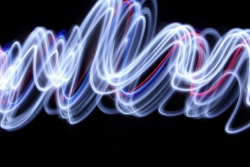 Long exposure photograph of bright white light in an abstract swirl, smokey waves pattern against a black background. Light painting photography.