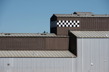 Partial view of a set of industrial warehouses under blue sky