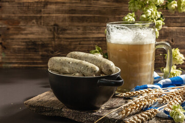 Oktoberfest set. Unfiltered beer, weisswurst, spikelets of grain, hop