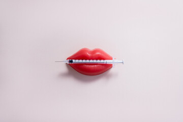 Plasticine lips and medical syringe. Lip injection creative concept. Copy space. - obrazy, fototapety, plakaty