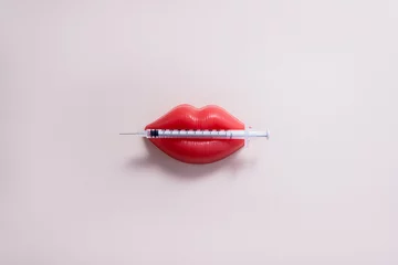 Fotobehang Plasticine lips and medical syringe. Lip injection creative concept. Copy space. © ClareM