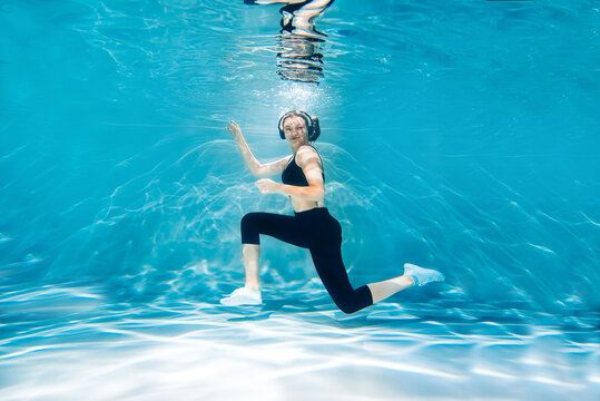 Running woman jogging. Girl under water, freshness and lightness, fitness and swimming. Sports and lifestyle