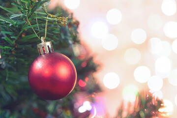 Christmas decoration. Red balls hanging on pine branches Christmas tree garland and ornaments over...