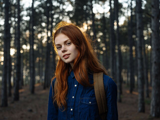 red-haired woman in forest nature travel walk freedom