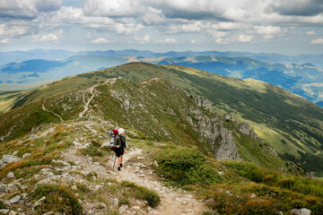 Fototapeta na wymiar Hiker on the top in Carpathians mountains. Travel sport lifestyle concept.