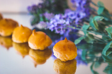 Delicious and appetizing profiterole are in a row