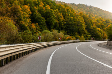 Highway and autumn landscape with vibrant fall colors. Empty mountain road in Turkey.