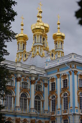 Fototapeta na wymiar Golden domes of Church and details of facade of emperors palace in Tsarskoe selo museum in Saint Petersburg, Russia