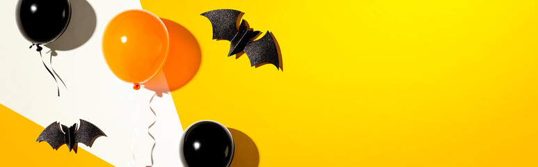 Orange and black balloons with bats - flat lay