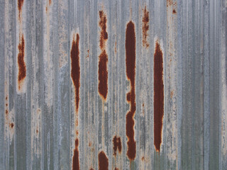 Metal, corrugated sheet with traces of rust. Abstract, creative background in gray tones.