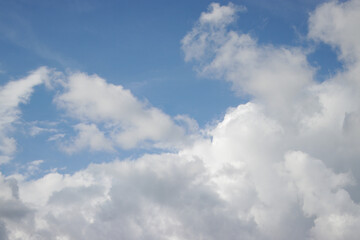 Naklejka na ściany i meble Cumulus clouds with a clear blue sky background in the midday. Types of clouds stock images.