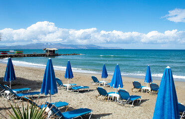 Crete island, Greece Agia Marina beach near Chania Parasols and sun loungers on the sands