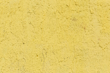 Yellow paint on old rough abstract wall texture background