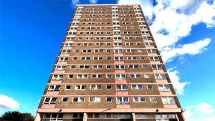 High rise 1960s apartment block, set against a blue sky in, Bramley, Leeds, UK
