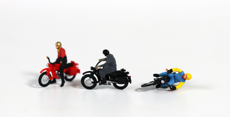 Miniature motorcycle rider. Miniature motorcycle driver who crashed. Concept about the risk of motorcycle accidents.
